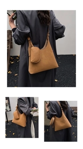 Detail shot of a brown oversized faux suede shoulder bag with a matching mini earbud pouch