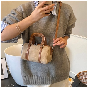 Detail of a vintage khaki frosted suede Boston bag with brown leather trim and shoulder strap