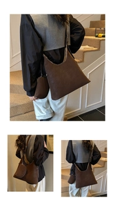 Detail view of large vintage brown tote bag set with matching small pouch for commuting