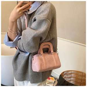 Pink frosted Boston bag detail with embossed cartoon design and detachable strap