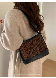 Detail of leopard print canvas and black leather patchwork on a retro shoulder bag