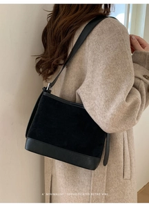 Minimalist retro black shoulder bag on model with sophisticated vintage vibe