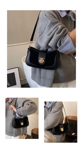 Detail of black leather shoulder bag with vintage gold round buckle and adjustable strap