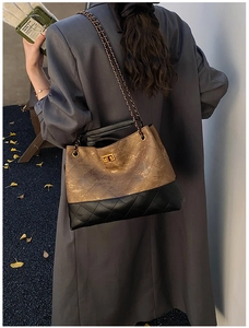Close-up of dual-tone quilted chain bag with bronze texture and gold twist lock