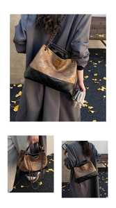 Detail of quilted leather tote featuring color-block design and metal chain strap