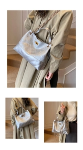 Detail of silver quilted tote bag with gold twist lock and metal chain strap