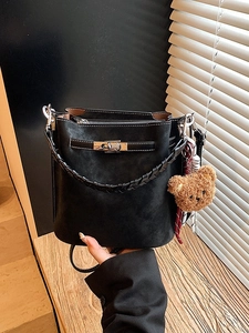 Vintage black suede bucket bag with contrast stitching and metal lock for autumn