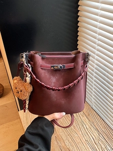 Retro burgundy suede bucket bag with metal twist lock and cute teddy bear charm