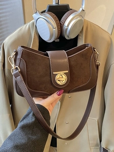 Dark brown retro underarm bag with suede texture and elegant gold oval lock detail