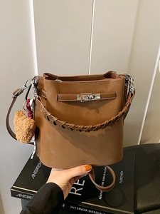 Retro brown suede bucket bag with woven handle and plush bear charm for autumn style