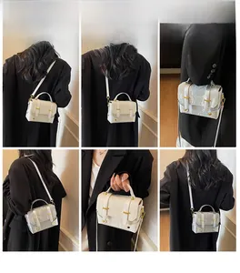 Detail view of a white vintage crossbody bag with gold hardware and versatile straps