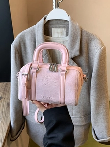 Pink vintage matte handbag with embossed cartoon dog and adjustable shoulder strap