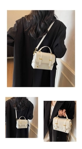 Detail view of white vintage crossbody bag with marble texture and golden hardware