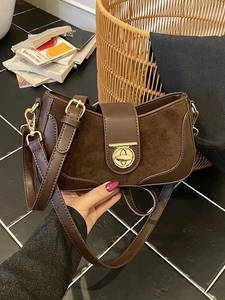 Brown half-moon underarm bag in leather and suede with gold hardware and adjustable strap