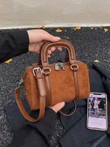 Retro brown Boston barrel handbag with leather stitching and twin top handles