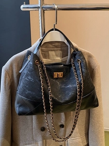 Black quilted chain shoulder bag featuring high-quality faux leather and gold turn-lock