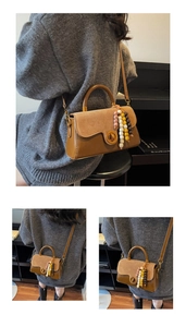 Detail of vintage patchwork handbag with suede finish, round metal clasp, and beaded tassel