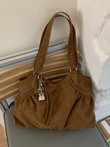 Brown vintage suede tote bag with silver rivets, drawstring sides and star charms