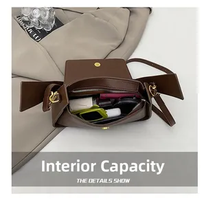Internal capacity of the brown lychee leather bag showing daily items and pockets