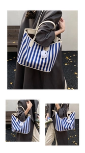 Outdoor shot showing a blue and white striped tote bag with a white bear charm detail
