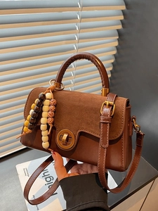 Retro patchwork handbag in dark brown leather and suede with colorful beaded tassel charm