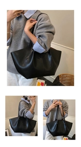 Close-up of a black leather tote bag featuring natural texture and slim shoulder straps