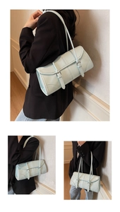 Detailed view of light blue oil wax leather baguette bag with silver buckles and quilting
