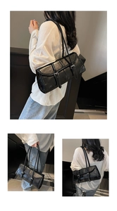Detail shots of black oil-wax leather baguette bag with minimalist buckle strap design