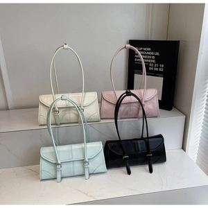 Detail of elegant oil wax leather baguette bags in four trendy colors with double buckles