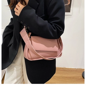 Chic mauve underarm bag with wide strap and pebble grain texture shown on model