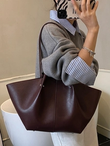 Large dark burgundy trapezoid leather tote bag with vertical stitching for women