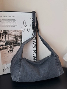 Vintage gray washed denim hobo bag with adjustable shoulder strap and cylinder shape