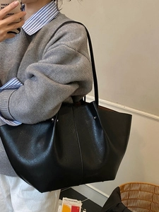 Chic black wing-shaped large tote bag with textured leather and long shoulder straps