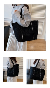 Detail of large black leopard print tote bag featuring silver rivet studs and suede texture