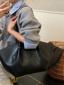 Minimalist black large capacity wing-shaped tote bag with pleated side detail for women