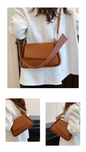 Detailed view of brown lychee texture leather underarm bag with gold-tone hardware