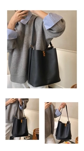 Détail d'un sac seau en cuir grainé noir avec un fermoir rotatif en métal doré