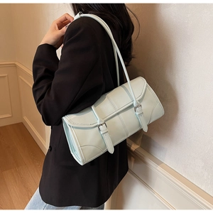 Detail of light blue oil wax leather baguette bag featuring elegant silver buckles