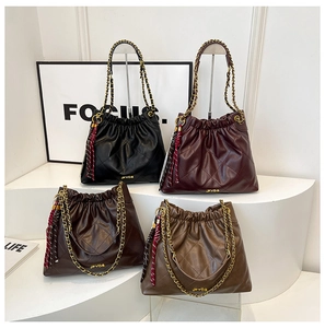 Quilted leather chain bags in four colors with drawstring detail and tassel accents