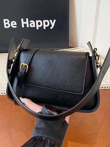 Chic black lychee leather shoulder bag for women with gold hardware and flap closure