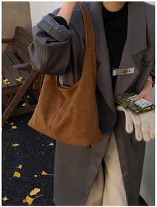 Detail of brown vintage hobo bag showing contrast stitching and premium matte leather texture