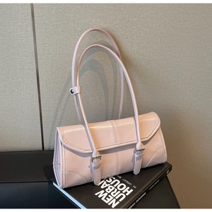 Detail view of pink baguette bag with glossy wax leather texture and silver buckles