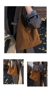 Detail of dark brown suede tote bag with contrast stitching and large capacity