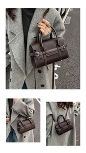Detail of dark brown leather handbag with contrast stitching and silver metal buckle closure