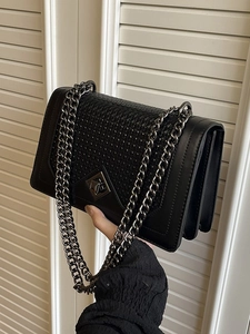 Retro black chain shoulder bag featuring woven texture flap and gun-metal buckle detail