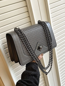 Gray woven chain shoulder bag with metallic turn-lock closure and pleated side design