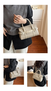 Detail of beige pebble leather Boston bag with stitching and adjustable strap
