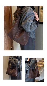 Detail view of large brown suede tote bag with contrast white stitching and soft texture