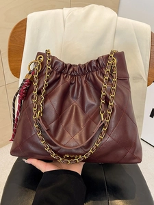 Chic burgundy quilted tote bag with golden chain straps for office and casual wear