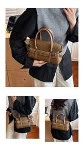 Detailed view of brown litchi grain leather handbag with contrast stitching and metal hardware